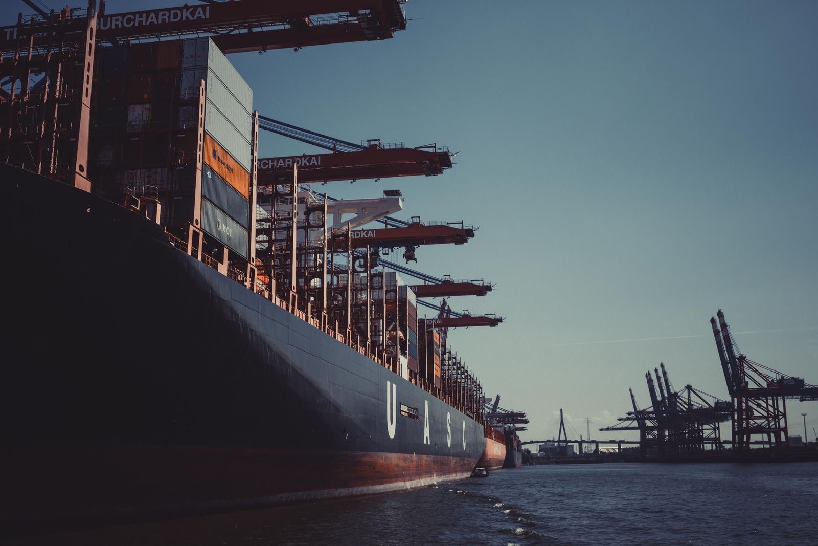 Container ship at a port terminal at dusk