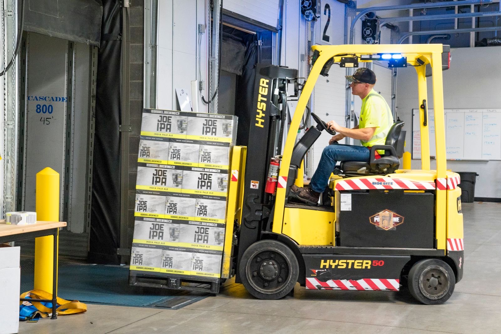 Forklift handling pallets at a loading dock